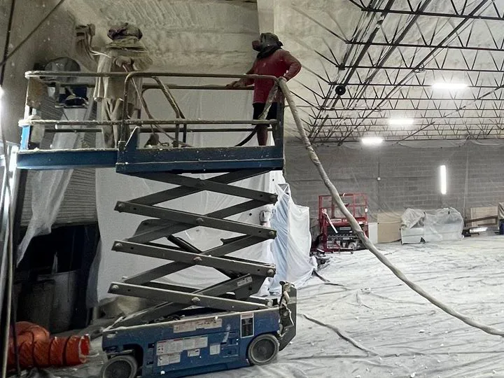 Employee at Hill Country Spray Foam Insulation spraying a commercial property. Experience the depth of industry knowledge and expertise that sets Hill Country Spray Foam Insulation apart in this captivating image. As leaders in the San Antonio insulation sector, our unmatched skill and dedication are vividly showcased in our work, symbolizing our unwavering commitment to delivering top-tier insulation services.