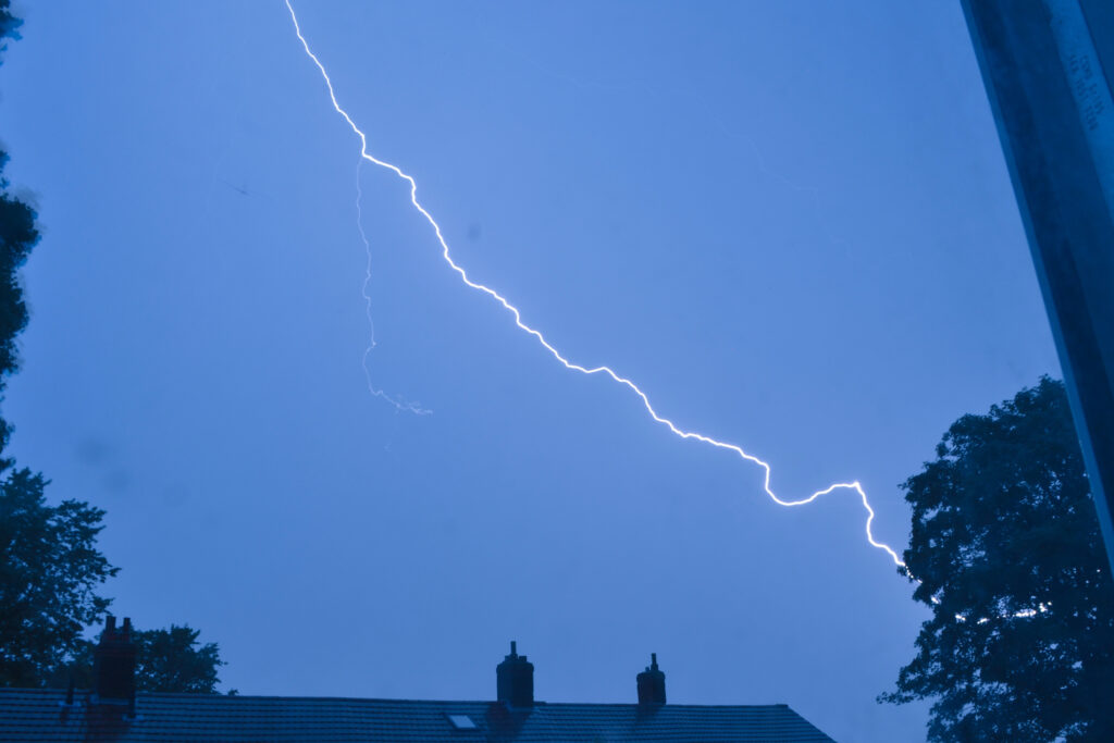 Lightning strike over house at night