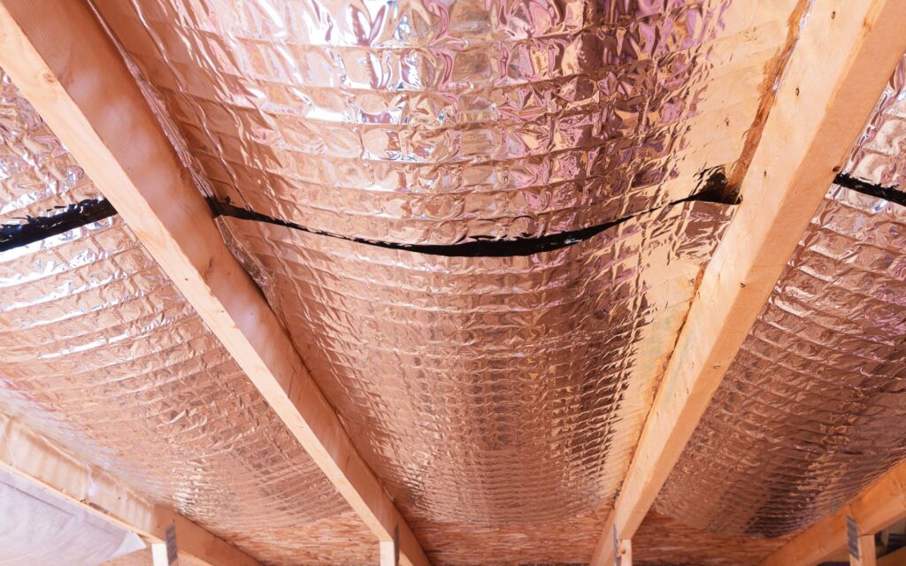 Radiant barrier under wooden beams